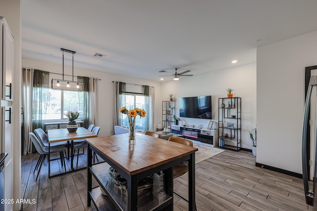 dining space with wood finish floors, recessed lighting, and ceiling fan