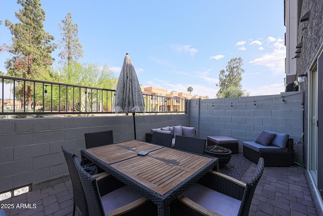 view of patio / terrace featuring outdoor lounge area and fence