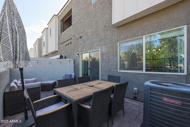 view of patio / terrace with an outdoor living space, outdoor dining space, central air condition unit, and fence