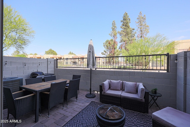 view of patio / terrace with outdoor dining area, fence, central AC unit, and outdoor lounge area