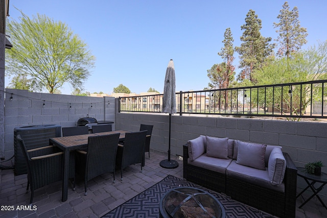 view of patio with outdoor lounge area, outdoor dining space, and fence