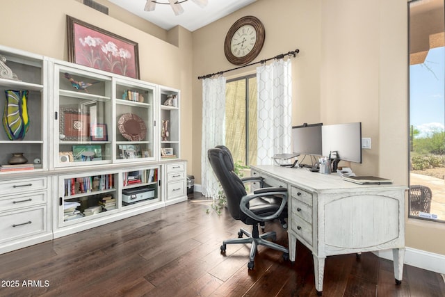 office with baseboards, a ceiling fan, dark wood finished floors, and visible vents
