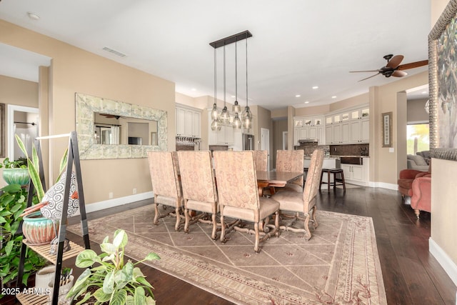 dining room with baseboards, ceiling fan, dark wood-type flooring, and visible vents