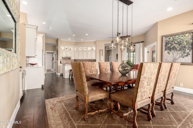 dining area featuring baseboards, recessed lighting, dark wood finished floors, and a notable chandelier