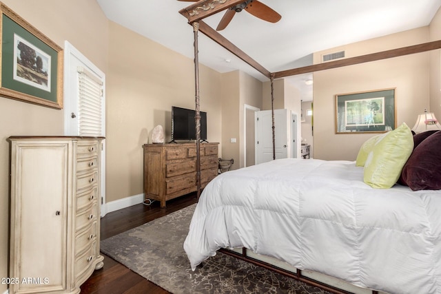 bedroom featuring visible vents, a ceiling fan, dark wood finished floors, and baseboards