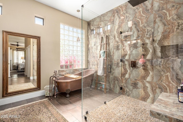 full bathroom with a freestanding tub, a shower stall, a wealth of natural light, and tile patterned flooring