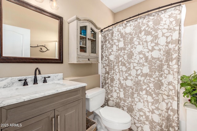 bathroom featuring vanity, toilet, and curtained shower