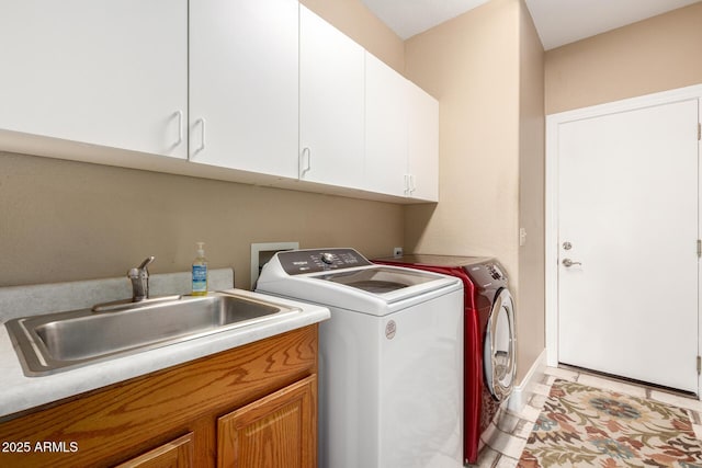 washroom with separate washer and dryer, a sink, and cabinet space