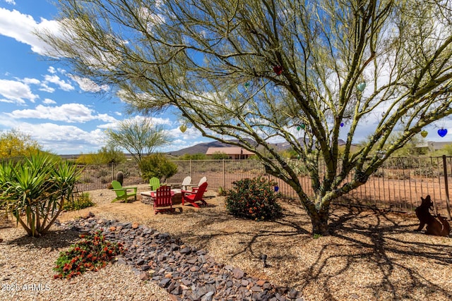 view of yard featuring fence and a mountain view