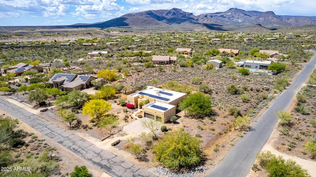 birds eye view of property with a mountain view and a desert view