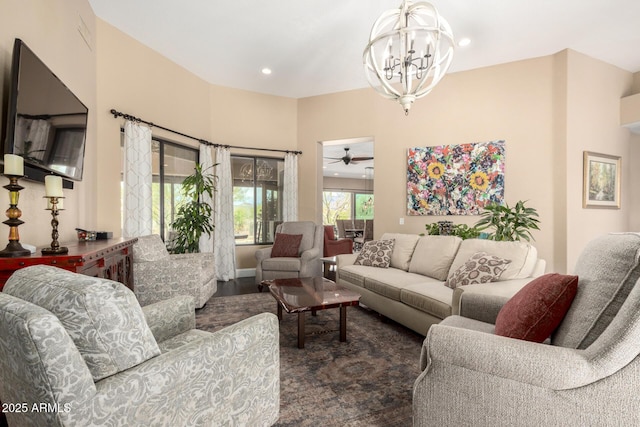 living room with recessed lighting and ceiling fan with notable chandelier