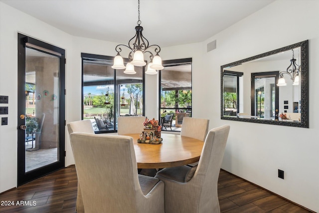 dining area featuring a notable chandelier and dark hardwood / wood-style floors