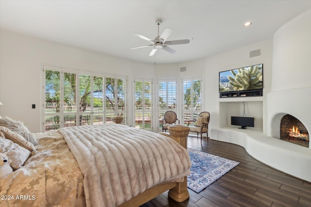 bedroom with access to exterior, ceiling fan, and dark hardwood / wood-style flooring