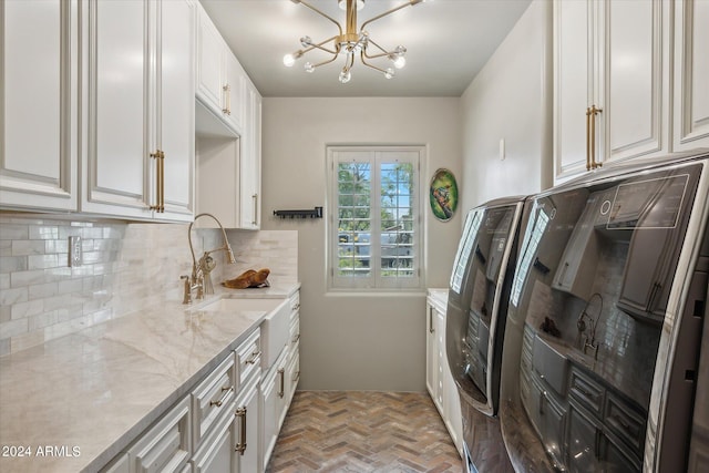 washroom featuring cabinets, an inviting chandelier, and sink