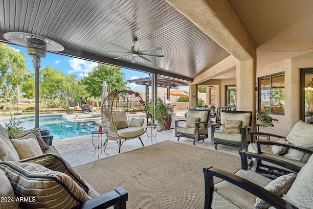 view of patio / terrace featuring ceiling fan and a fenced in pool