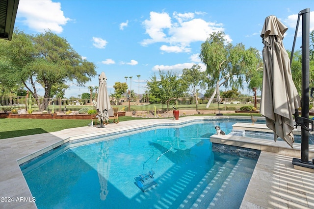 view of swimming pool featuring a patio area, a lawn, and a jacuzzi