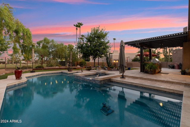 pool at dusk featuring a pergola and a patio area