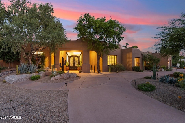 pueblo revival-style home featuring french doors