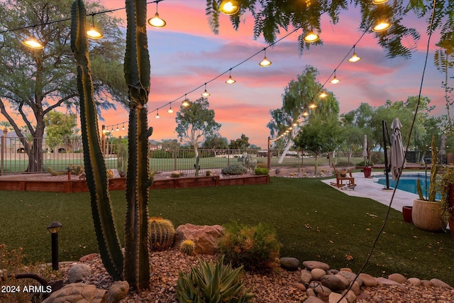 view of community with a yard and a pool