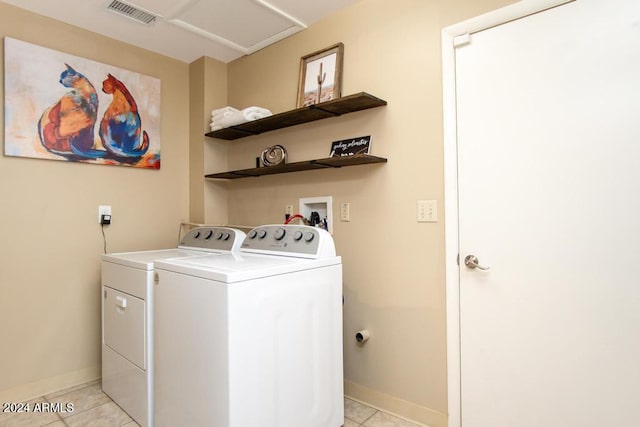 washroom featuring light tile patterned floors and washing machine and clothes dryer