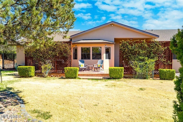 rear view of property featuring a lawn and a wooden deck