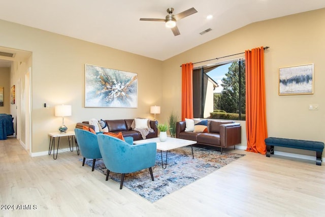 living room with ceiling fan, lofted ceiling, and light hardwood / wood-style flooring