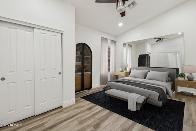 bedroom with lofted ceiling, visible vents, ceiling fan, and light wood-style flooring