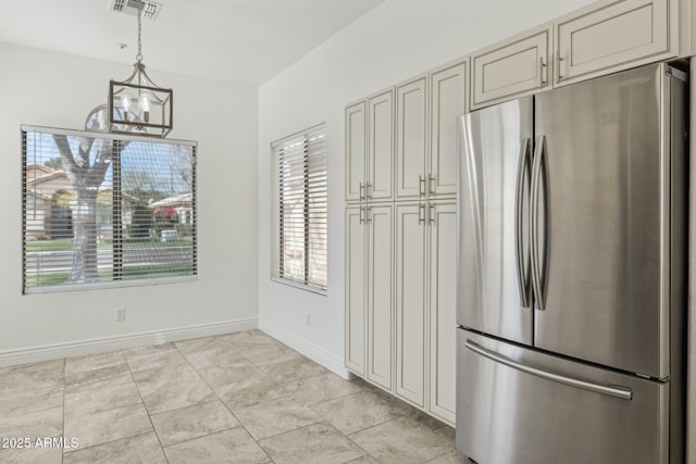 kitchen featuring a chandelier, visible vents, baseboards, hanging light fixtures, and freestanding refrigerator