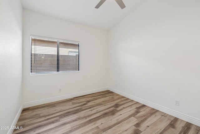 unfurnished room with light wood-type flooring, vaulted ceiling, baseboards, and ceiling fan