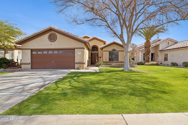 mediterranean / spanish home with a tile roof, stucco siding, an attached garage, driveway, and a front lawn