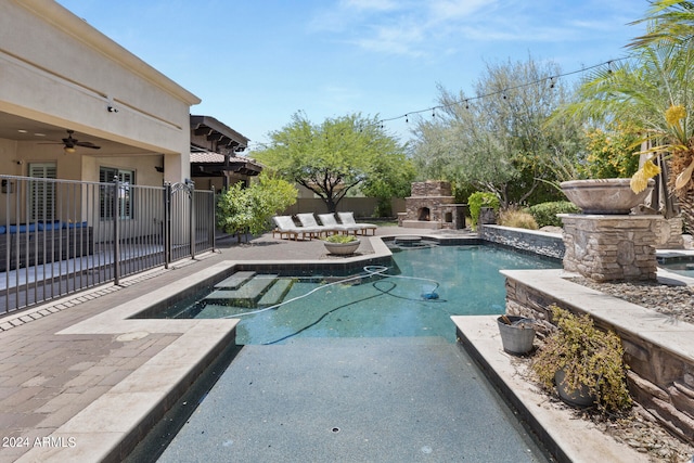 view of pool with an outdoor living space with a fireplace, a patio, and ceiling fan