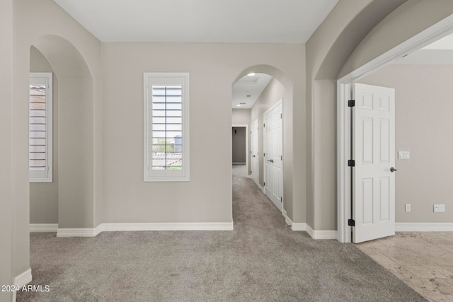 hallway with light colored carpet