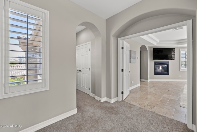 hallway with light colored carpet