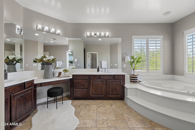 bathroom featuring a washtub and vanity