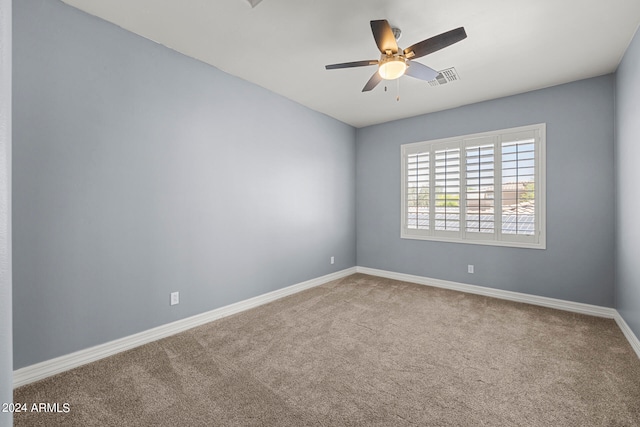 empty room with carpet flooring and ceiling fan