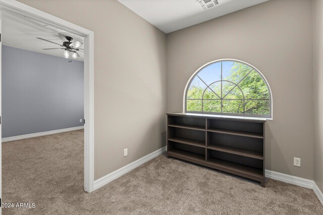 interior space featuring ceiling fan and light carpet