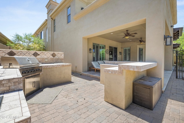 view of patio featuring a grill and an outdoor kitchen