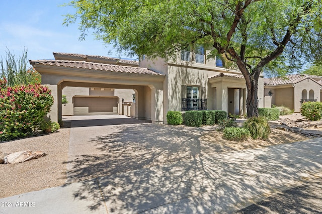 mediterranean / spanish home with a garage