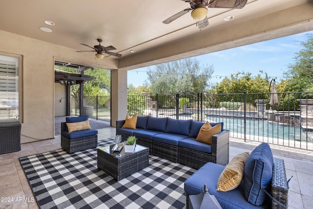 view of patio featuring outdoor lounge area, ceiling fan, and a fenced in pool