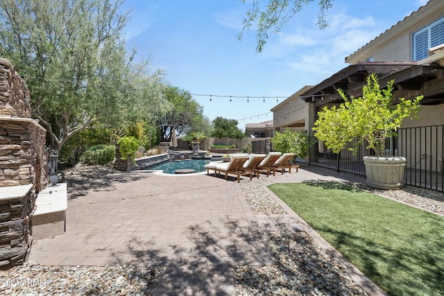 exterior space featuring a swimming pool with hot tub and a patio