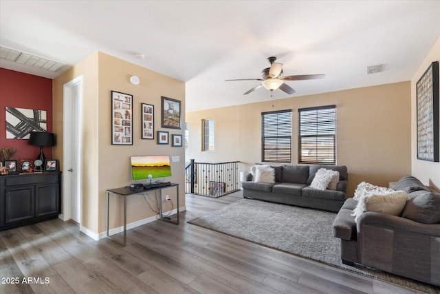 living room with hardwood / wood-style flooring and ceiling fan