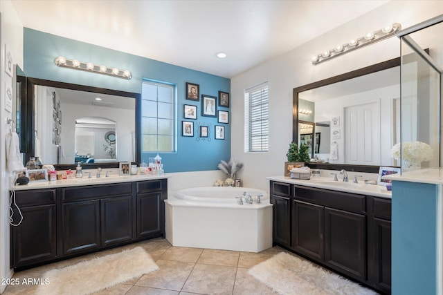 bathroom featuring tile patterned flooring, vanity, and a tub