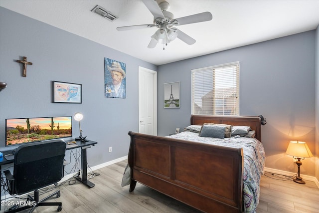 bedroom with ceiling fan and light hardwood / wood-style flooring