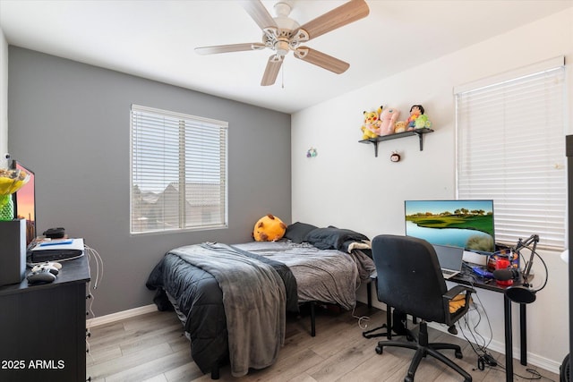 bedroom with ceiling fan and light hardwood / wood-style floors