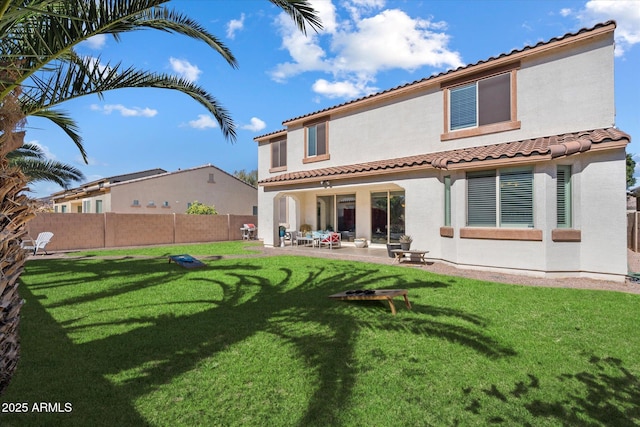 back of property with a patio and a lawn