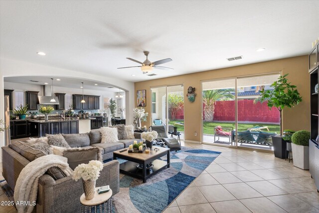 living room with light tile patterned floors and ceiling fan