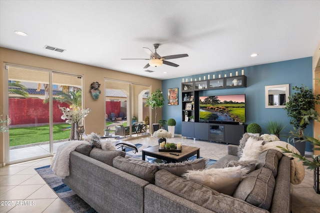 living room featuring light tile patterned floors and ceiling fan