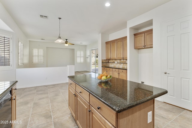 kitchen with black dishwasher, brown cabinetry, a kitchen island, pendant lighting, and backsplash