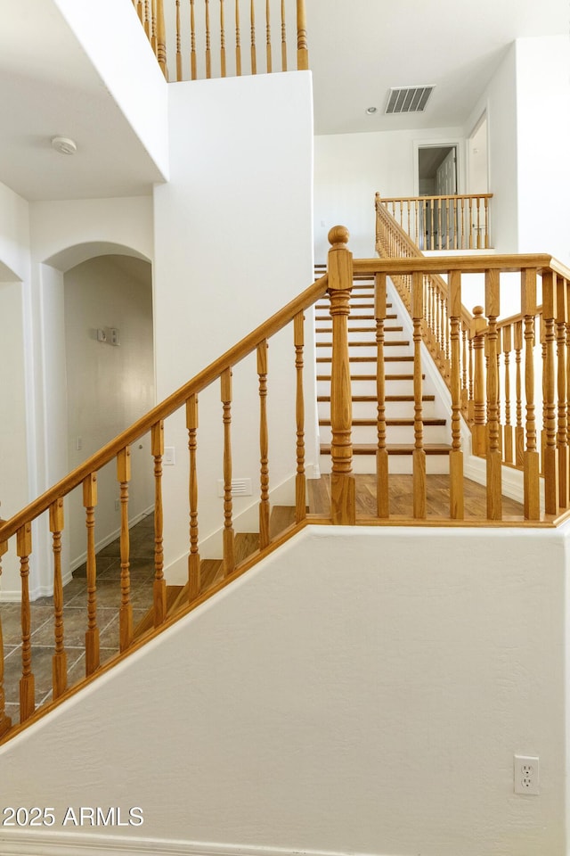 staircase featuring visible vents