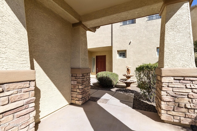 property entrance featuring stucco siding